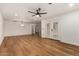 Open living room featuring sleek ceiling fan, light hardwood floors, and natural light from the french doors at 19013 N 18Th Ave, Phoenix, AZ 85027