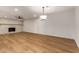 Spacious living room featuring new hardwood floors, a stone fireplace, and modern lighting fixtures at 19013 N 18Th Ave, Phoenix, AZ 85027