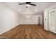 A spacious living room with a modern ceiling fan, beautiful light hardwood floors, and recessed lighting at 19013 N 18Th Ave, Phoenix, AZ 85027