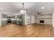 Open-concept living area featuring hardwood floors, stainless appliances, and a stone fireplace at 19013 N 18Th Ave, Phoenix, AZ 85027