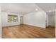 Bright living room with hardwood floors, white walls, base molding, and natural light from a window at 19013 N 18Th Ave, Phoenix, AZ 85027