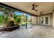 Covered patio with ceiling fans leading to a beautifully landscaped yard and outdoor area at 19013 N 18Th Ave, Phoenix, AZ 85027
