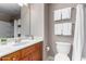 Bright bathroom features a white single sink vanity, white toilet, and shower with a white shower curtain at 1920 E Bell Rd # 1189, Phoenix, AZ 85022