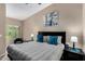 Serene bedroom featuring a king-size bed, blue accent pillows, and large windows, creating a peaceful retreat at 1920 E Bell Rd # 1189, Phoenix, AZ 85022