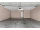 Clean, empty two car garage with smooth concrete floor and a door to the house at 1920 E Bell Rd # 1189, Phoenix, AZ 85022