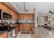 Well-lit kitchen featuring stainless steel appliances and granite countertops, flowing into an adjacent living space at 1920 E Bell Rd # 1189, Phoenix, AZ 85022