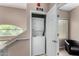Upstairs laundry closet with a stacked white washer and dryer at 1920 E Bell Rd # 1189, Phoenix, AZ 85022