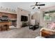 Open living room features modern TV, a plush sofa, staircase access, and seamless flow to the kitchen at 1920 E Bell Rd # 1189, Phoenix, AZ 85022