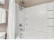 White shower and bathtub combination with white tile surround, chrome hardware, and shower caddy at 1920 E Bell Rd # 1189, Phoenix, AZ 85022