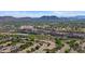 Panoramic aerial view of a community with views of a bustling highway and scenic mountains in the distance at 19530 N 84Th Ave, Peoria, AZ 85382