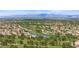 An aerial showcases community homes surrounding a picturesque golf course with a serene lake and tree-lined fairways at 19530 N 84Th Ave, Peoria, AZ 85382