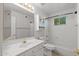 A bathroom featuring a single vanity, mirror, toilet, shower, and tub at 19530 N 84Th Ave, Peoria, AZ 85382