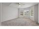 A spacious bedroom features neutral walls and carpet, and large windows at 19530 N 84Th Ave, Peoria, AZ 85382