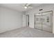 An empty bedroom with neutral colored walls and carpet, and sliding mirror door closet at 19530 N 84Th Ave, Peoria, AZ 85382