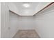 A walk-in closet with neutral carpet and a hanging rack at 19530 N 84Th Ave, Peoria, AZ 85382