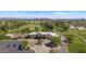 Aerial view of a clubhouse surrounded by a well-manicured golf course with palm trees, parking, and mountain views at 19530 N 84Th Ave, Peoria, AZ 85382