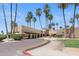 Luxurious community clubhouse entrance with lush landscaping and palm trees at 19530 N 84Th Ave, Peoria, AZ 85382