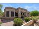 Exterior of home with desert landscaping and covered porch at 19530 N 84Th Ave, Peoria, AZ 85382
