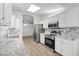 Updated kitchen features stainless steel appliances and granite countertops at 19530 N 84Th Ave, Peoria, AZ 85382