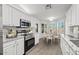 Modern kitchen with white cabinets, granite countertops, and stainless steel appliances at 19530 N 84Th Ave, Peoria, AZ 85382