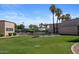 Lawn bowling setup on a lush green lawn, with benches and palm trees nearby at 19530 N 84Th Ave, Peoria, AZ 85382