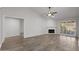 Spacious living room featuring a fireplace, hardwood floors, and a ceiling fan at 19530 N 84Th Ave, Peoria, AZ 85382