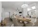 Open-concept dining and living area featuring modern decor and a fireplace at 19530 N 84Th Ave, Peoria, AZ 85382