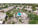Aerial view of a community pool area featuring a swimming pool, jacuzzi, desert landscape, and lounge chairs at 19530 N 84Th Ave, Peoria, AZ 85382