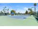 Well-maintained community tennis court with blue surface, lush landscaping, and ample lighting at 19530 N 84Th Ave, Peoria, AZ 85382
