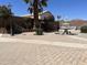 Well maintained backyard with a fountain feature, paved patio, mature trees and desert landscaping at 21873 W Pima St, Buckeye, AZ 85326