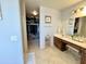 Bathroom with walk-in closet, dual sink vanity, and tile floor at 21873 W Pima St, Buckeye, AZ 85326