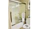 Clean bathroom featuring a shower with glass doors, white fixtures, and decorative accents at 21873 W Pima St, Buckeye, AZ 85326