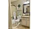 Bathroom with a shower and vanity featuring white cabinets, granite countertops, and a framed mirror at 21873 W Pima St, Buckeye, AZ 85326