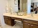 A bathroom vanity features dual sinks, a makeup counter with a stool, and a large mirror at 21873 W Pima St, Buckeye, AZ 85326