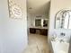Bathroom featuring a vanity with dual sinks, a makeup counter, and tile flooring at 21873 W Pima St, Buckeye, AZ 85326