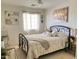 Comfortable bedroom featuring a decorative bed frame, neutral decor, and natural light at 21873 W Pima St, Buckeye, AZ 85326