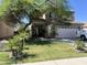 Charming two-story home with desert landscaping, mature shade trees and a two car garage at 21873 W Pima St, Buckeye, AZ 85326