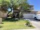Inviting two-story home with mature landscaping including a large shade tree, a two car garage and a charming front porch at 21873 W Pima St, Buckeye, AZ 85326