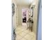 Hallway with neutral paint, tile flooring, and view into the office/study area at 21873 W Pima St, Buckeye, AZ 85326