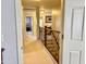 Upstairs hallway with wood and iron railing leading to bedrooms and living spaces at 21873 W Pima St, Buckeye, AZ 85326