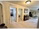 Hallway leading to bedrooms and living spaces with a decorated cabinet at 21873 W Pima St, Buckeye, AZ 85326