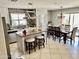 Bright kitchen with granite countertops, backsplash, island with seating, and dining area with chandelier at 21873 W Pima St, Buckeye, AZ 85326