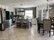 Modern kitchen with stainless steel appliances, a center island with bar seating, and stylish tile backsplash at 21873 W Pima St, Buckeye, AZ 85326