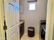 Laundry room features new front load machines, built-in storage, and tiled flooring at 21873 W Pima St, Buckeye, AZ 85326