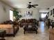 Cozy living room featuring tile floors, a ceiling fan, and comfortable seating, creating an inviting atmosphere at 21873 W Pima St, Buckeye, AZ 85326