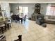 Open-concept living and dining area with tiled floors and backyard access at 21873 W Pima St, Buckeye, AZ 85326
