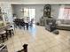 Open-concept living and dining area with tiled floors and backyard access at 21873 W Pima St, Buckeye, AZ 85326
