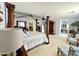 Large main bedroom showcasing a canopy bed, neutral carpet, and attached bath at 21873 W Pima St, Buckeye, AZ 85326