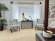 Bright bedroom featuring neutral carpet, stylish chairs, and a large window at 21873 W Pima St, Buckeye, AZ 85326
