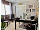 Bright office space with dark desk, computer, neutral walls, and a cozy work atmosphere at 21873 W Pima St, Buckeye, AZ 85326